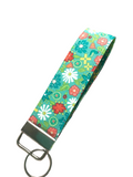 Gingham Cottage Floral patterned key fob on a woven surface