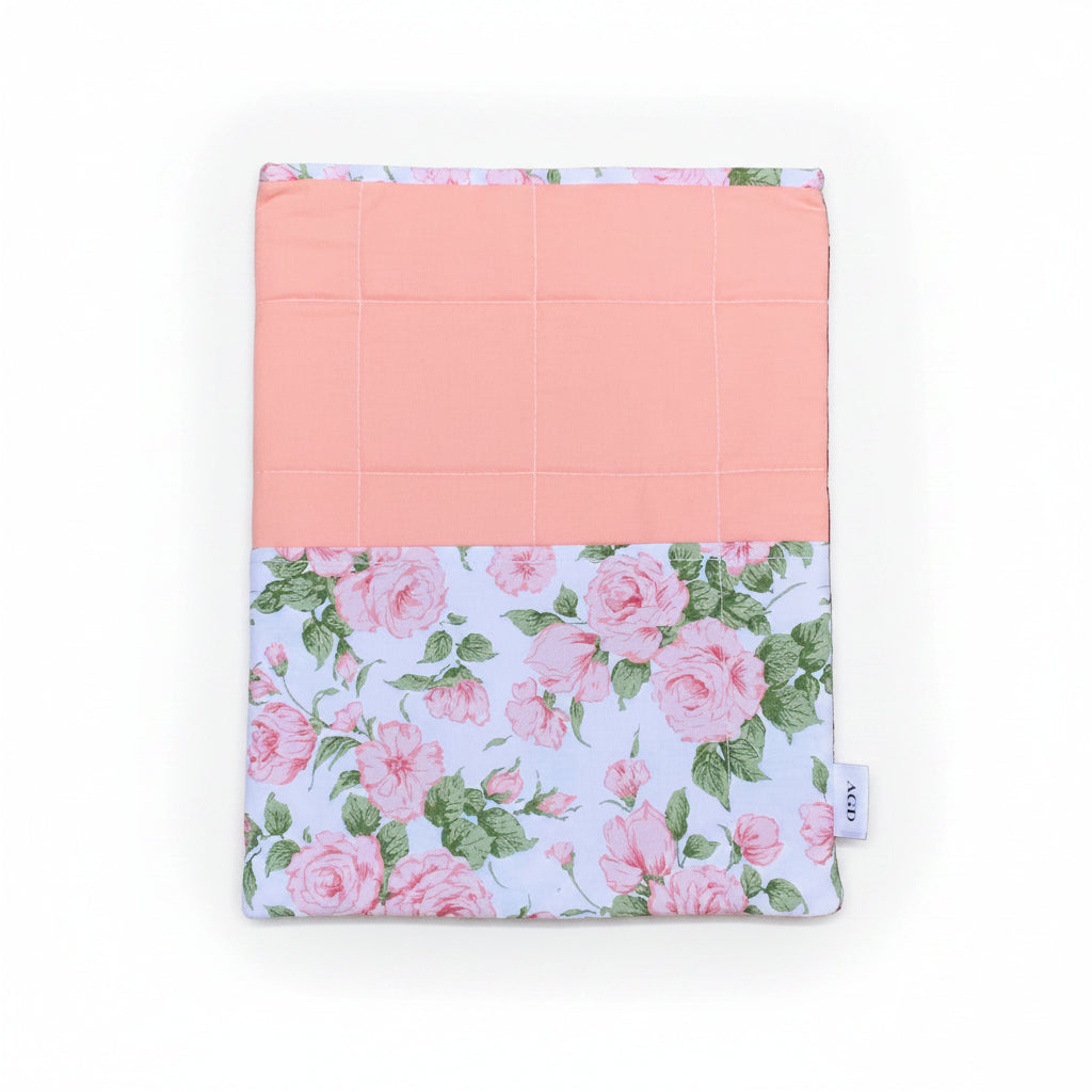 Floral notebook cover with pink interior on a stone surface