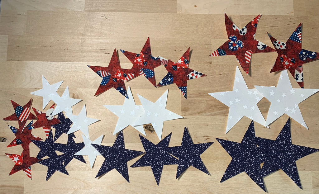 Decorative applique stars in red, white, and blue on a wooden surface