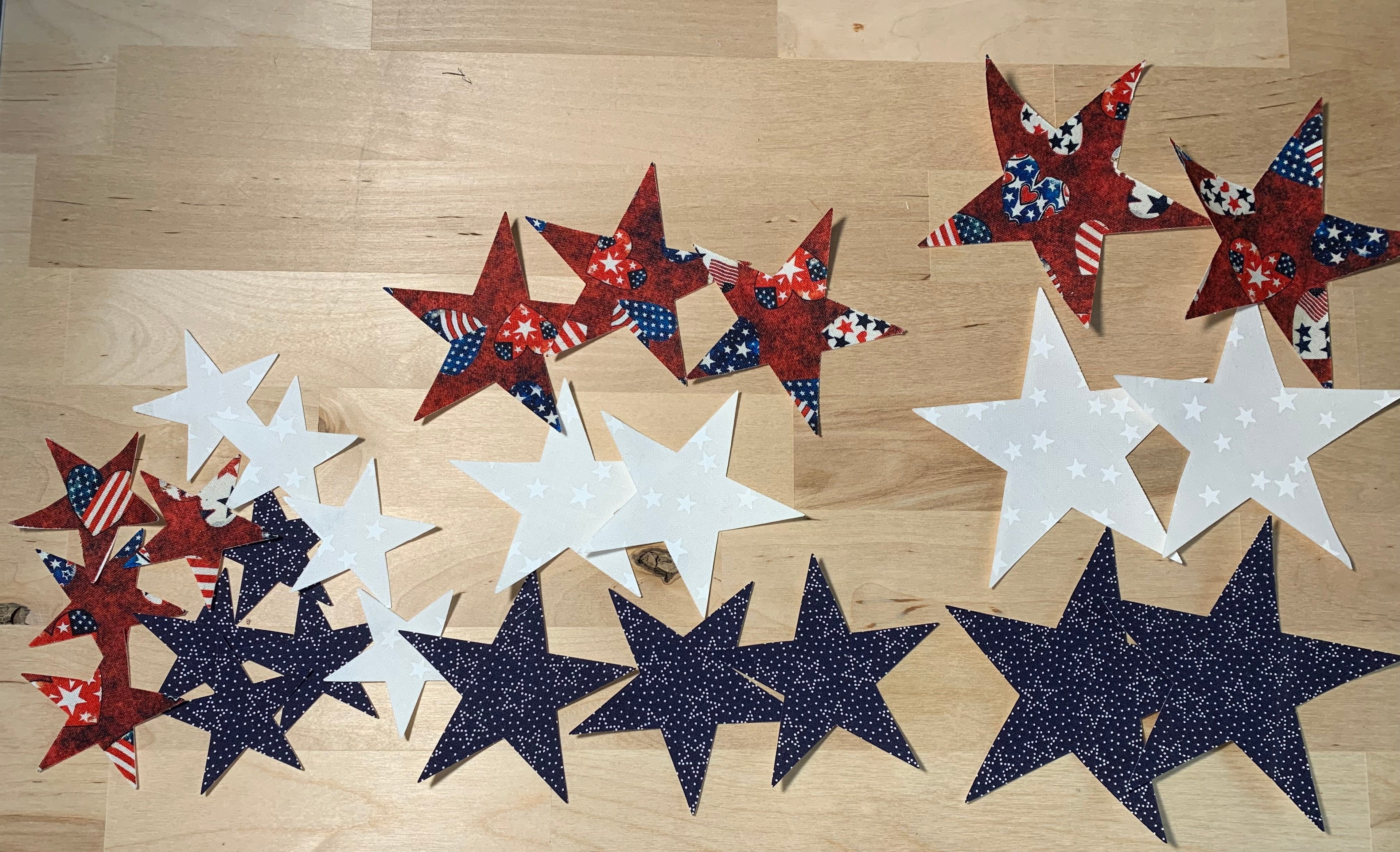 Decorative applique stars in red, white, and blue on a wooden surface