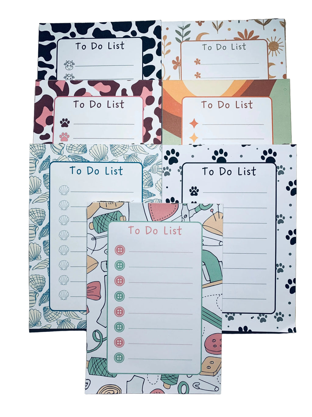 Set of colorful to-do list pads with various designs on a wooden surface.