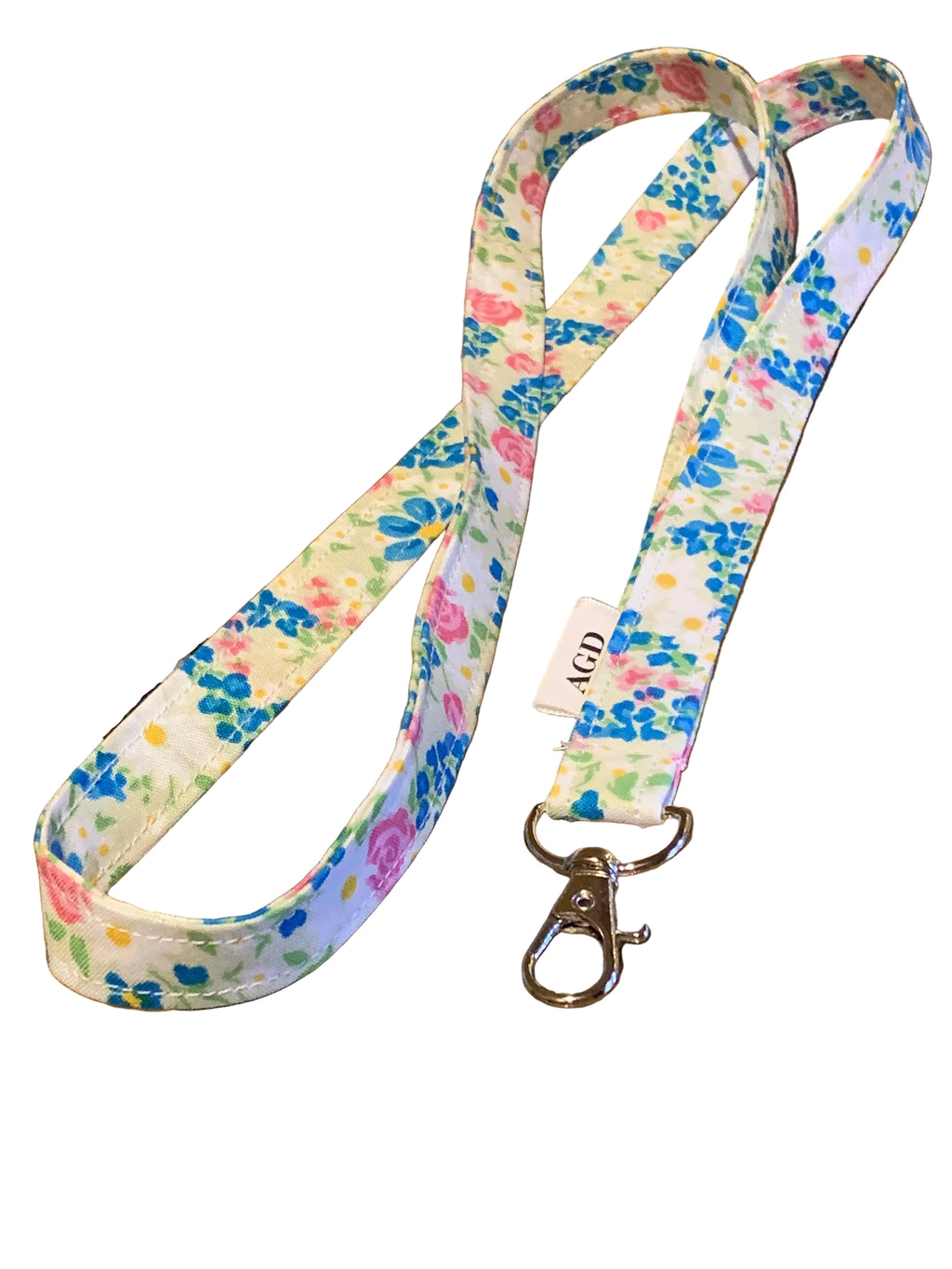 Floral patterned lanyard with a clip on a wooden surface