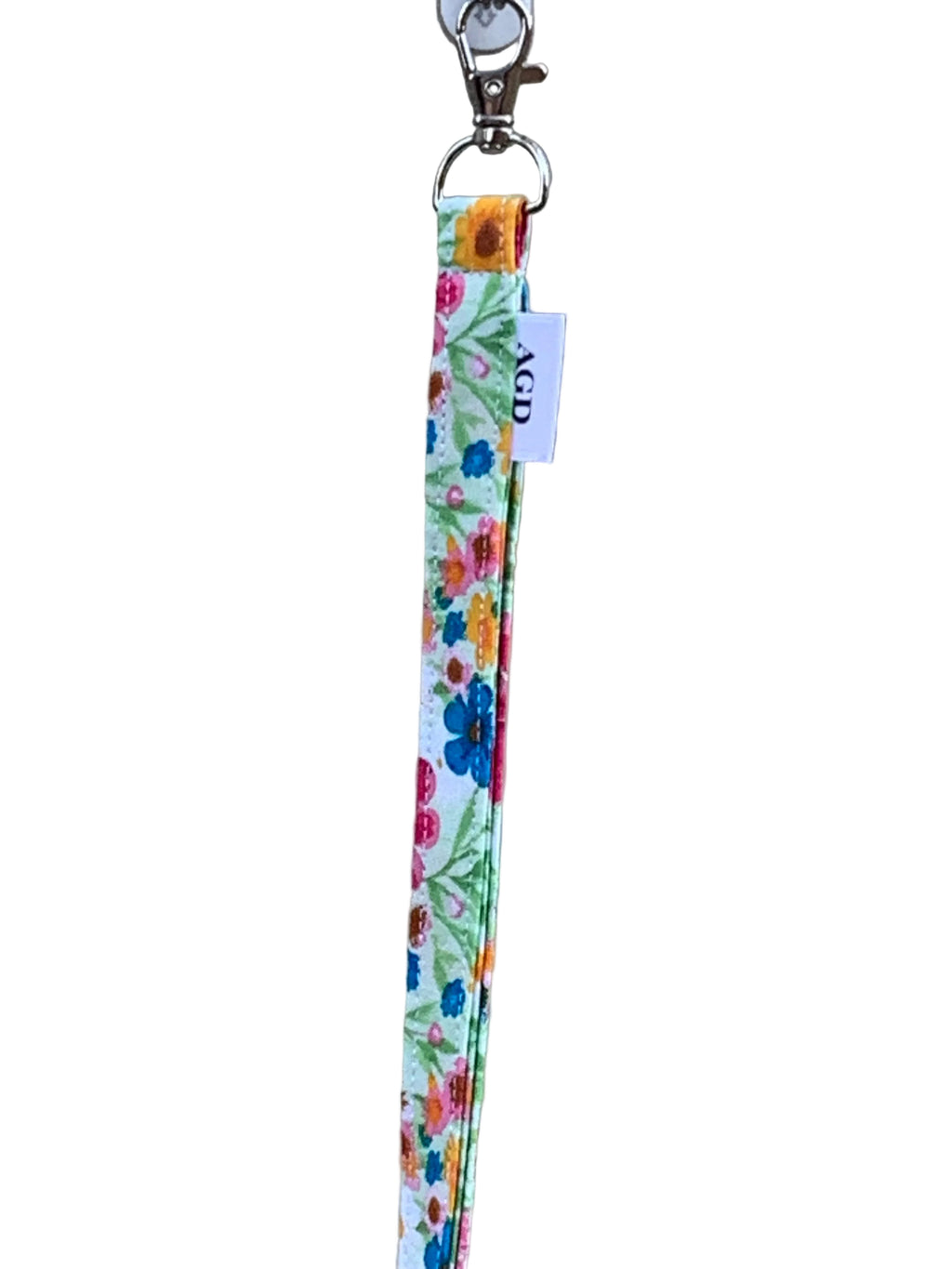 Floral patterned lanyard with a clip on a plain background