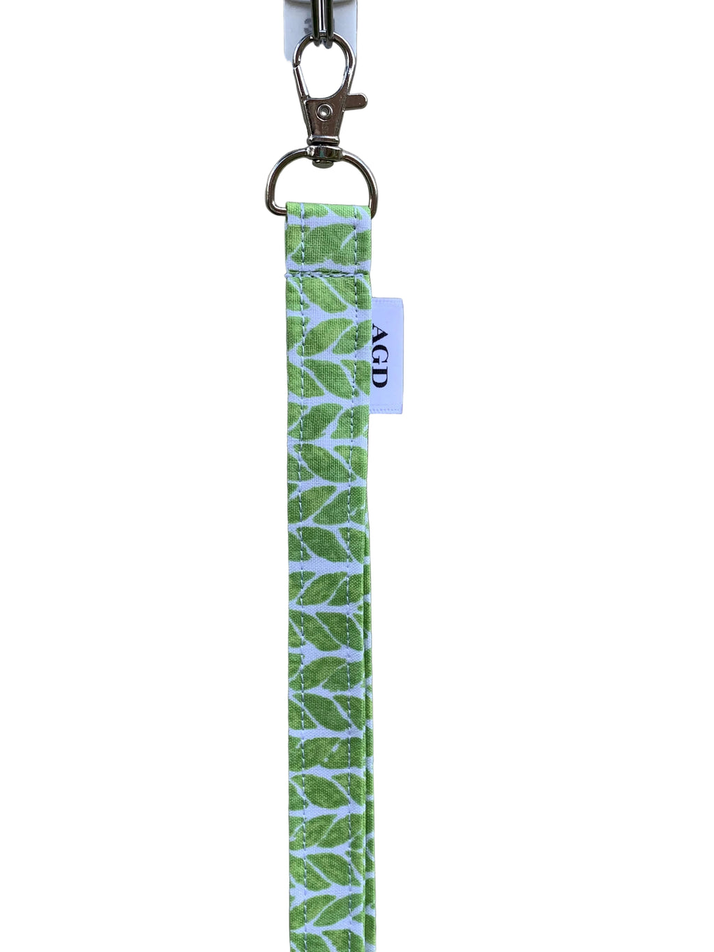 Green and white patterned keychain on a plain background