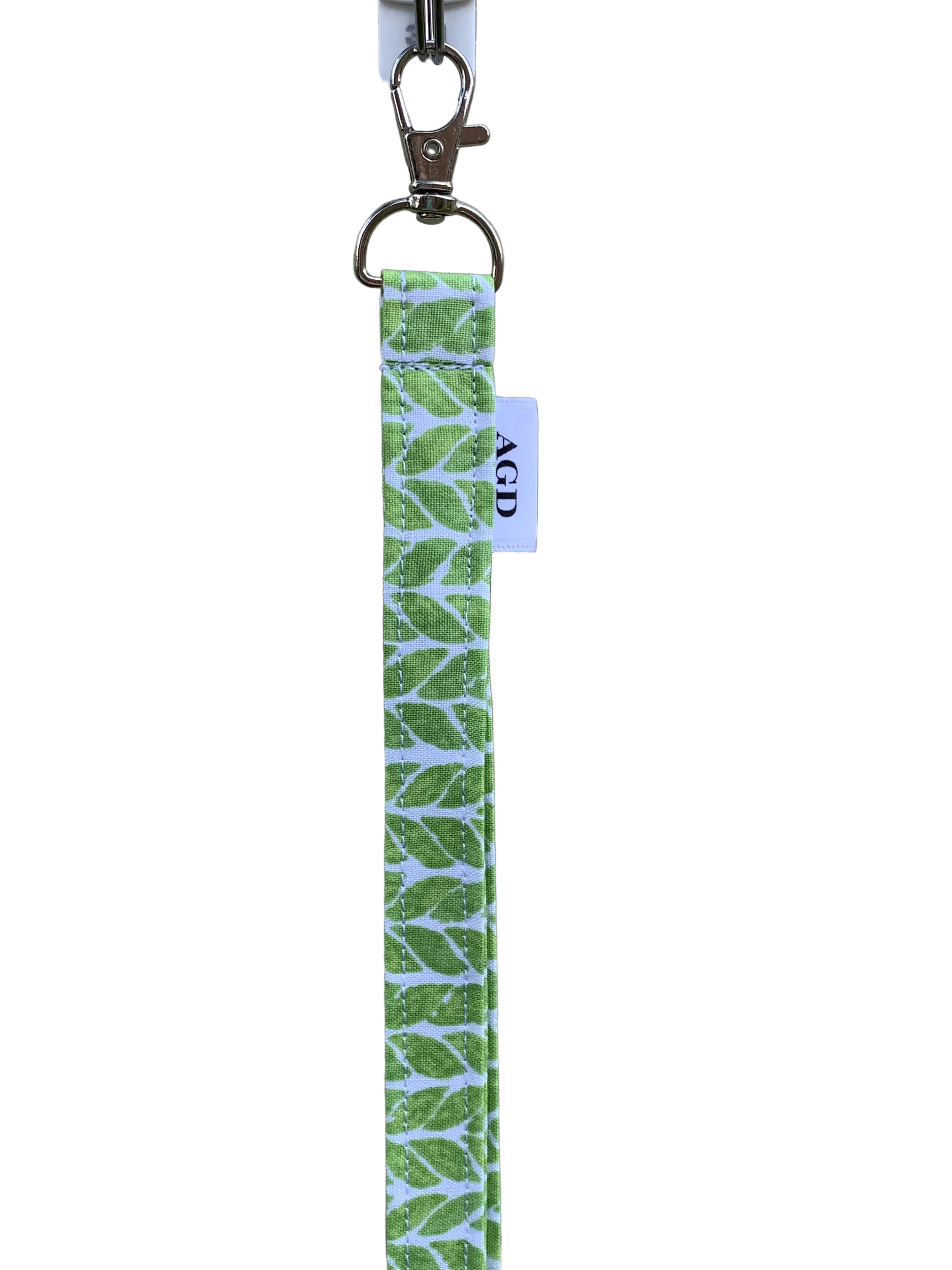 Green and white patterned keychain on a plain background