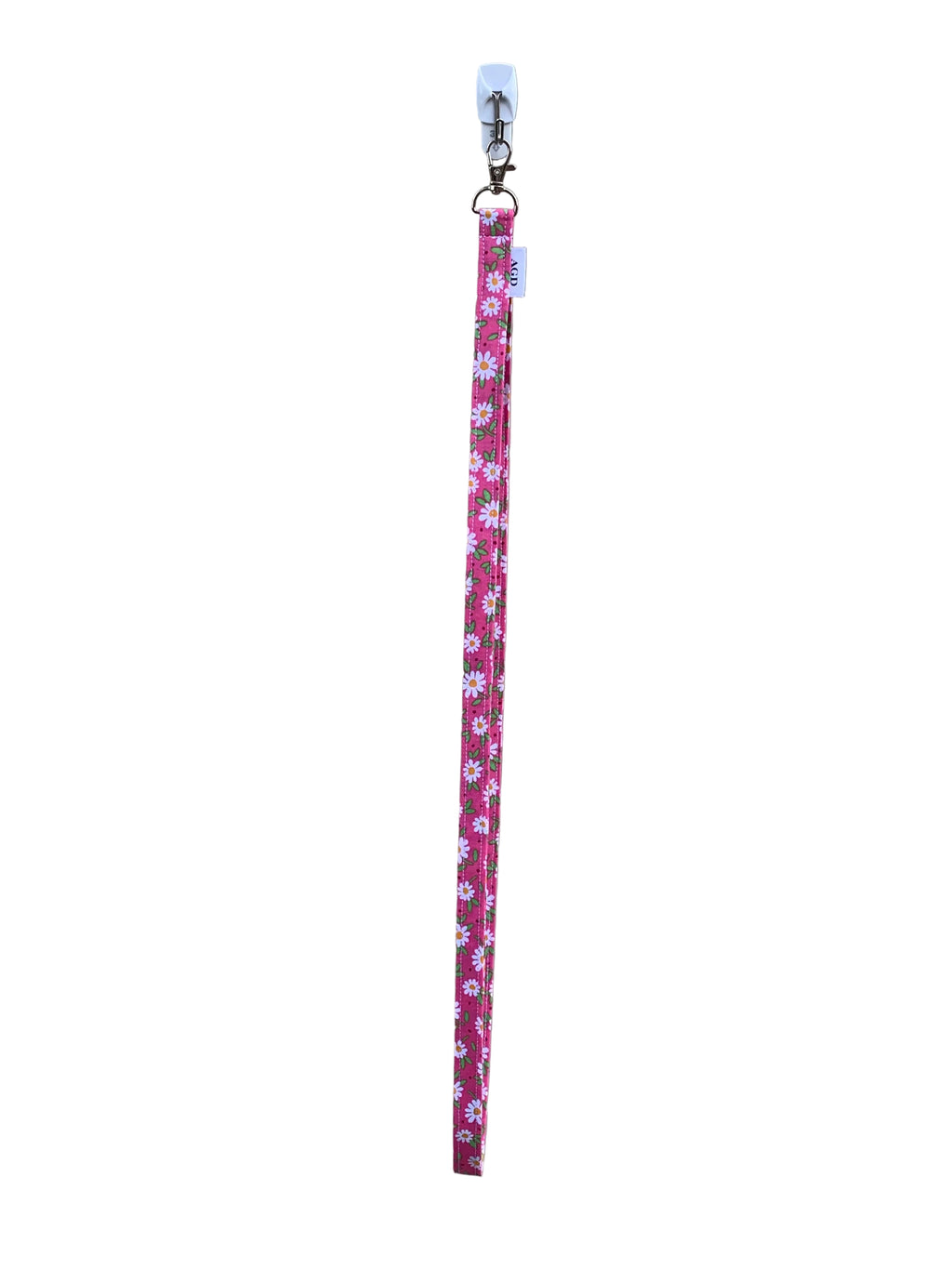Pink floral lanyard with a clip on a light gray background