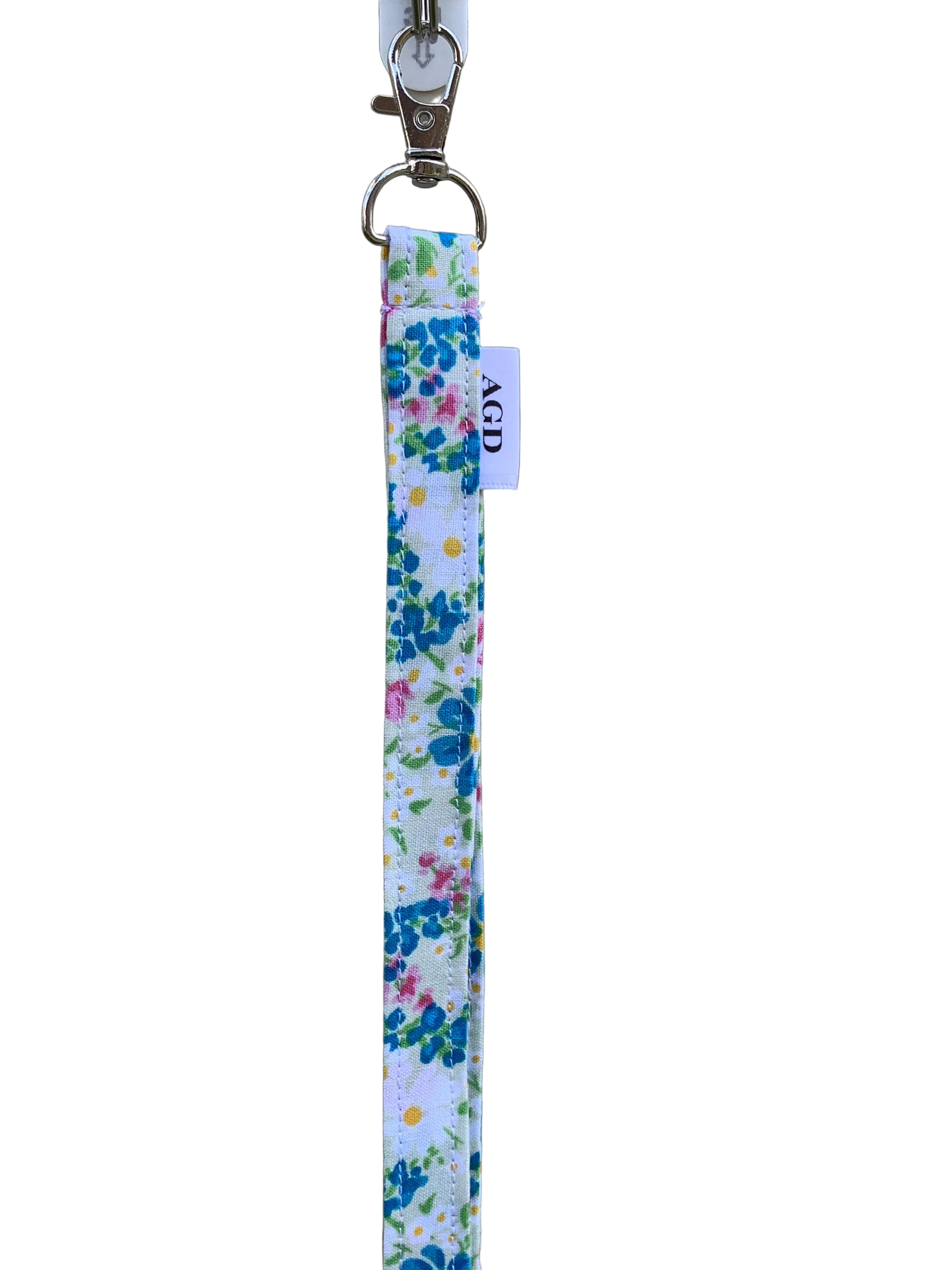 Floral keychain strap with a visible brand tag on a plain background